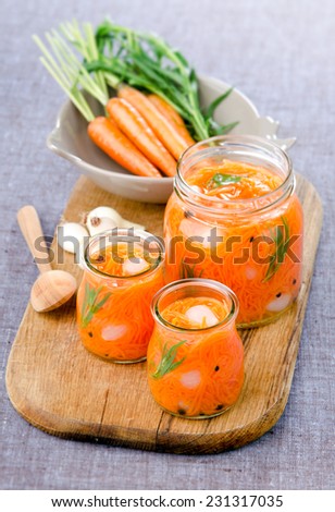 preserves home-made pickled carrots Canned onions with herbs in glass jars