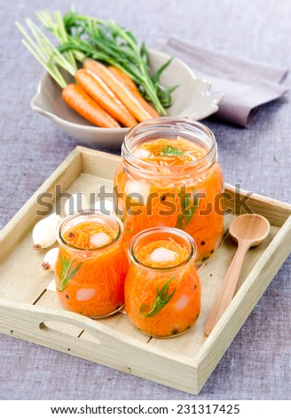 home-made pickled carrots Canned onions with herbs in glass jars