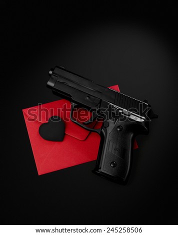 black gun black heart on a red envelope black background