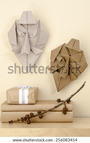 interior decoration origami masks on the wall near the boxes with gifts on a shelf