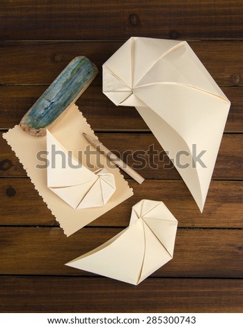 origami decor art nautilus shell on a wooden table interior decoration