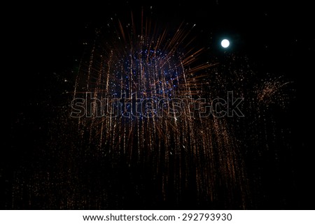 golden and blue fireworks against night background  with moon for new year celebration
