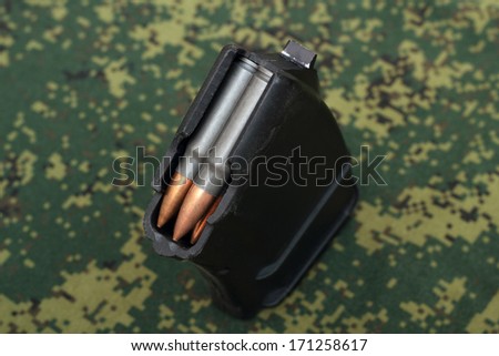 Filled magazine viewed from mouth on digital camouflage background