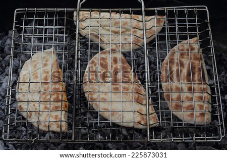 Roasted arabic bread pita on the grill photo
