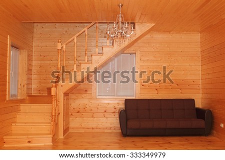 Wooden house interior - corner stairs and sofa photo