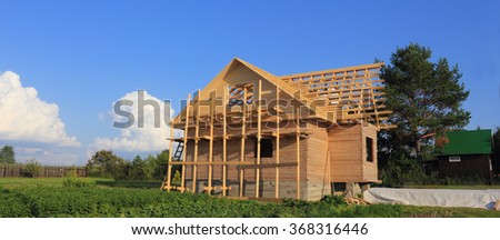 Timber house under constructoin with roof frame photo