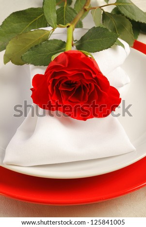 Romantic dinner setting with a rose