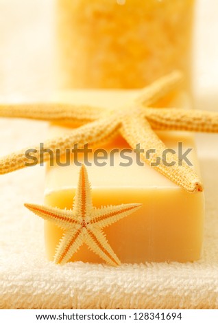 Bars of soap with bath salt, starfish on white towel