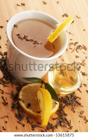a cup of green tea with honey and lemon