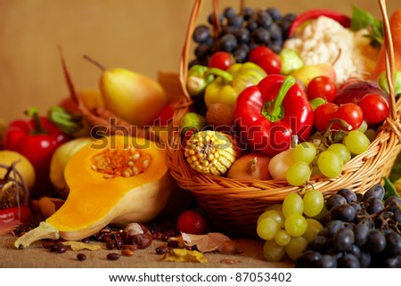 Still life with autumn vegetables and fruits on burlap background