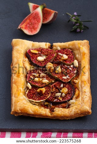 Gourmet puff pastry tart with figs, almonds, blue cheese and honey