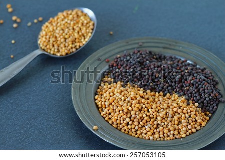 Yellow and black mustard seeds
