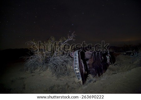 Abandoned vintage auto in the desert, under the stars, Joshua Tree National Park