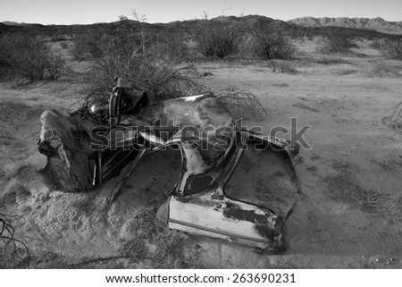 Abandoned vintage auto in the desert, landscape in black and white, Joshua Tree National Park