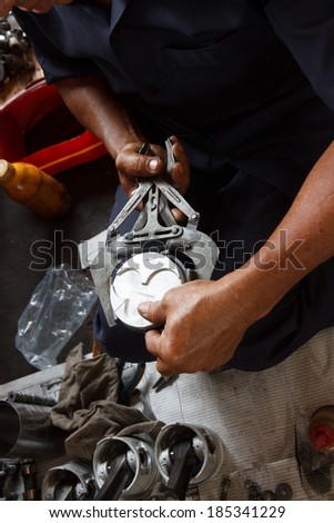 automotive mechanic disassembling car engine with  during automobile maintenance at repair service station