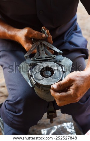 automotive mechanic disassembling car engine with during automobile maintenance at repair service station