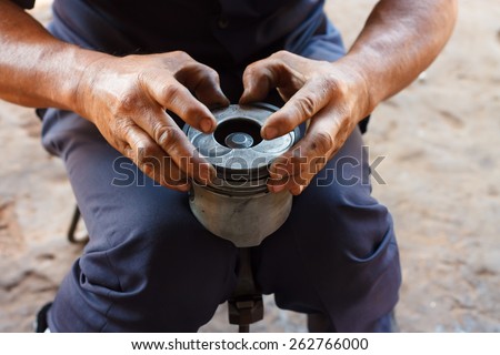 automotive mechanic disassembling car engine with during automobile maintenance at repair service station