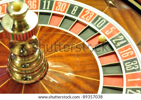 image with a casino roulette wheel with the ball on number 5