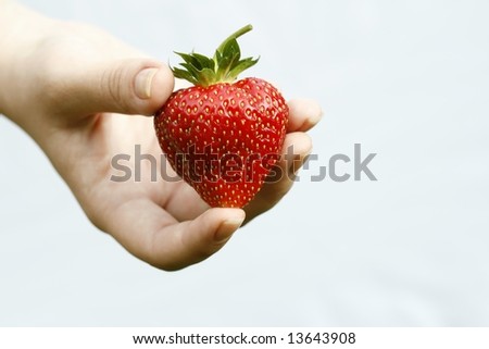 Big strawberry in hand