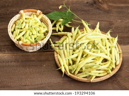 Raw beans, fresh legumes and its stem in the basket