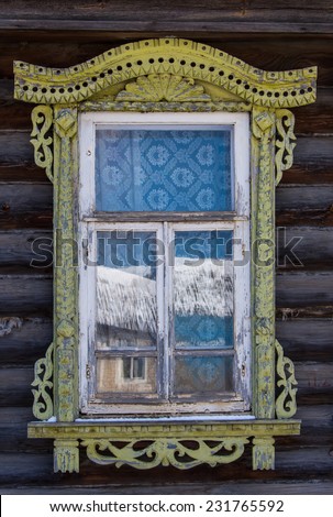 Elements of decoration of windows in an old Russian house - window trim, wooden ornaments