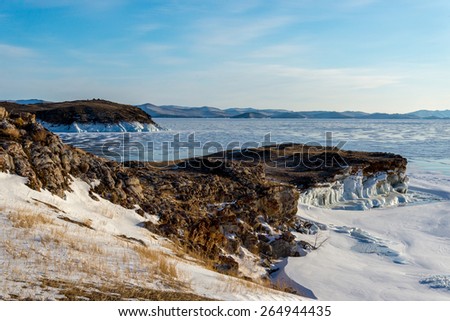 Winter landscape on the shores of ice Lake Baikal, Russia