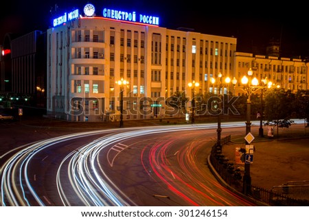 KHABAROVSK - JUL 26: The moving stream of cars at night along the main street of Khabarovsk (inscription on the house: Special construction Russia) on July 26, 2015 in Khabarovsk, Russia