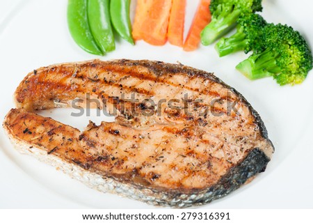 Grilled Salmon Steak with Boiled Vegetables Isolated on a White Background