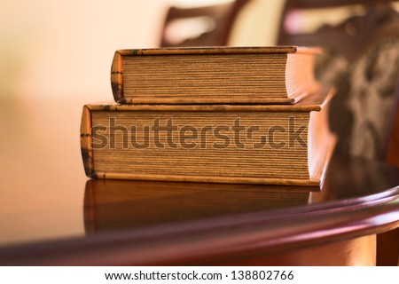 Old ancient book composition over the table as a home interior background