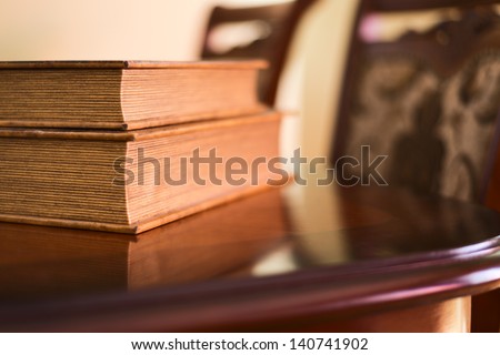 Old ancient book composition over the table as a home interior background