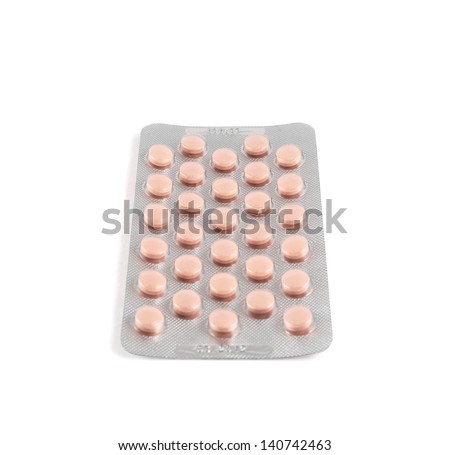 Blister bubble pack of round pink pills isolated over white background