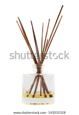 Wooden aroma sticks in a glass flask filled with flavor liquid substance isolated over white background, side view