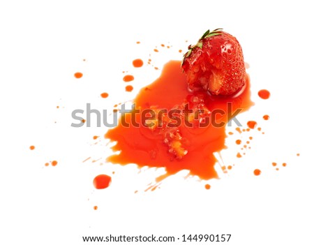Squashed strawberry in the puddle of red juice isolated over white background