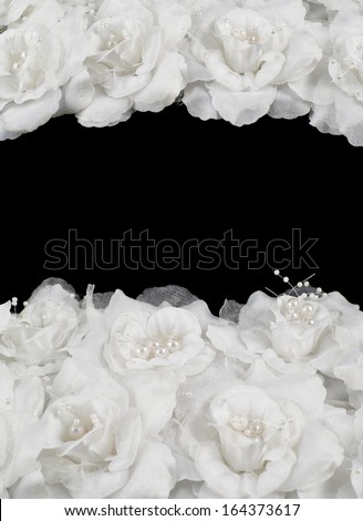Artificial white roses over black background