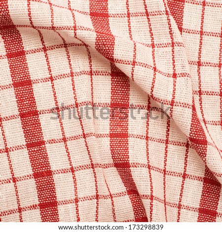 Checkered red and white fragment of wrinkled cloth as a background composition