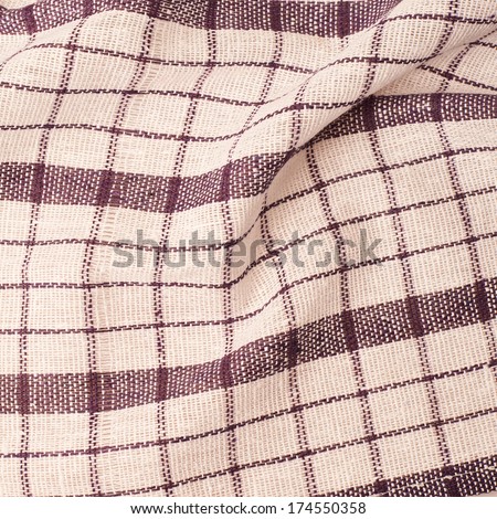 Checkered violet and white fragment of wrinkled cloth as a background composition