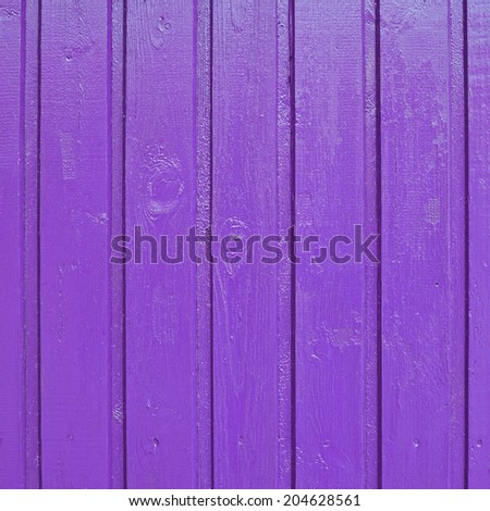 Painted violet wooden fence fragment as a background texture