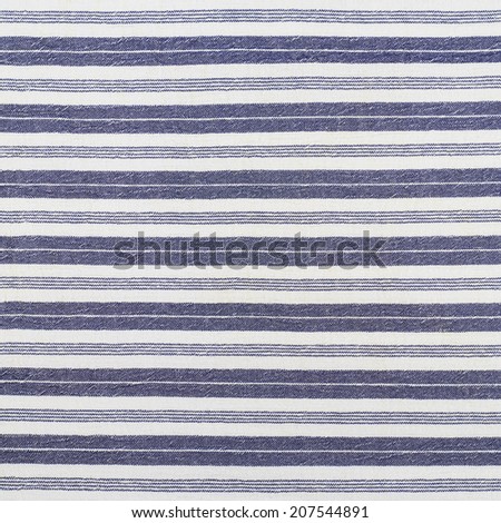 Fragment of a striped white and blue cloth fabric as a background texture