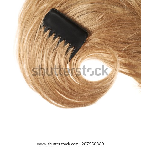 Open wave hair fragment with a black comb placed over the white background as a copyspace backdrop composition