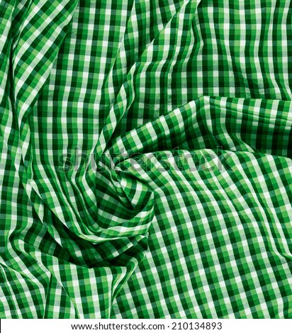 Wrinkled squared green cloth fabric fragment as an abstract background composition