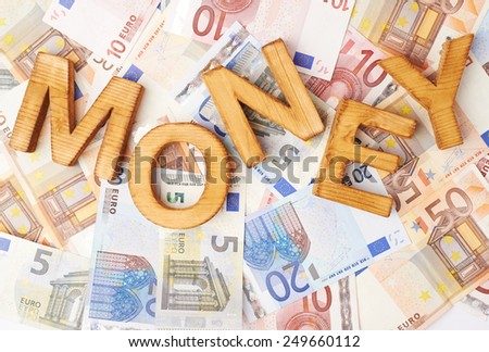 Word Money over the surface covered with the euro bank note bills