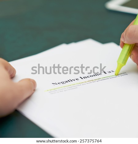 Marking words in a negative income tax definition, shallow depth of field composition