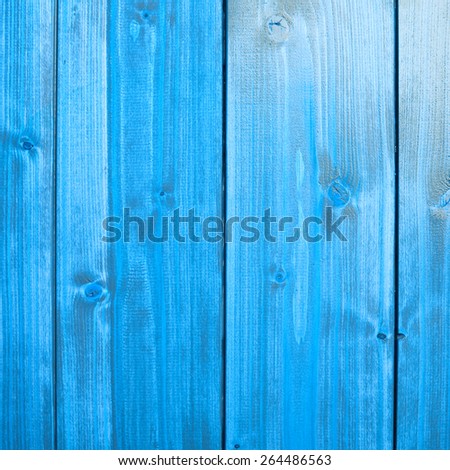 Blue paint coated wooden pine boards lying in a row as a close-up background composition