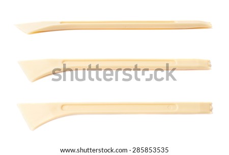 Plastic knife tool for working with clay plasticine isolated over the white background, set of three different foreshortenings