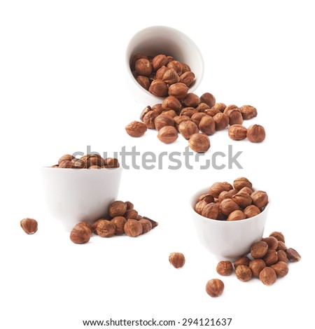 White ceramic cup bowl filled with the multiple hazelnuts isolated over the white background, set of three different foreshortenings