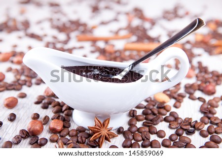 white gravy boat with chocolate and coffee beans