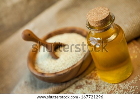 sesame oil and sesame seeds on table