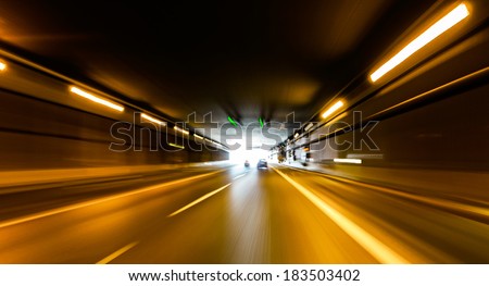 A car going full speed at the end of the tunnel A car going full speed at the end of the tunnel