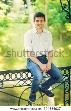 Portrait of a smiling young man on nature
