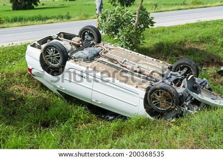 SUKHOTHAI THAILAND-JUNE 22,2014 : car turned upside down at the side of the road because driver is doze off but not be injured.